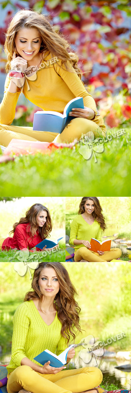 Girl with book on green grass 0404
